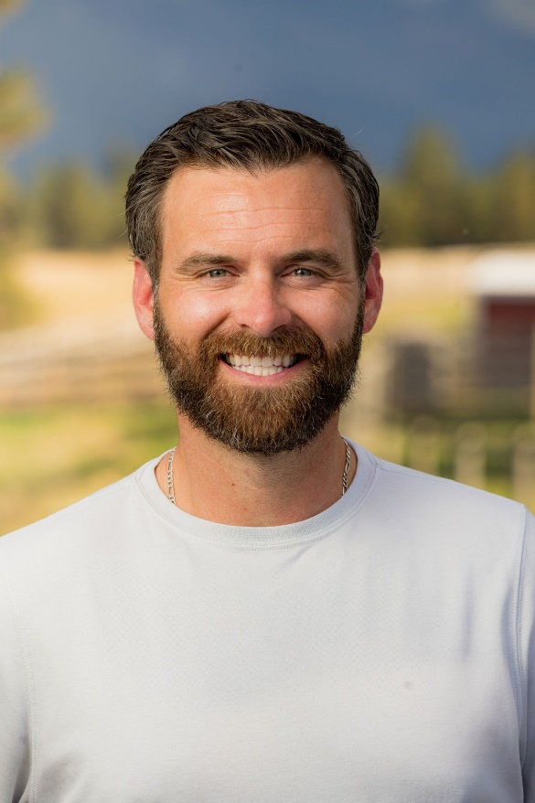 A person with a beard smiling

Description automatically generated