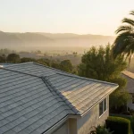 A residential tile roof at sunrise, a reminder to decide how often your roof needs maintenance.