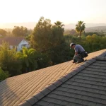 A roofer demonstrates the benefits of annual roof maintenance during a professional inspection.