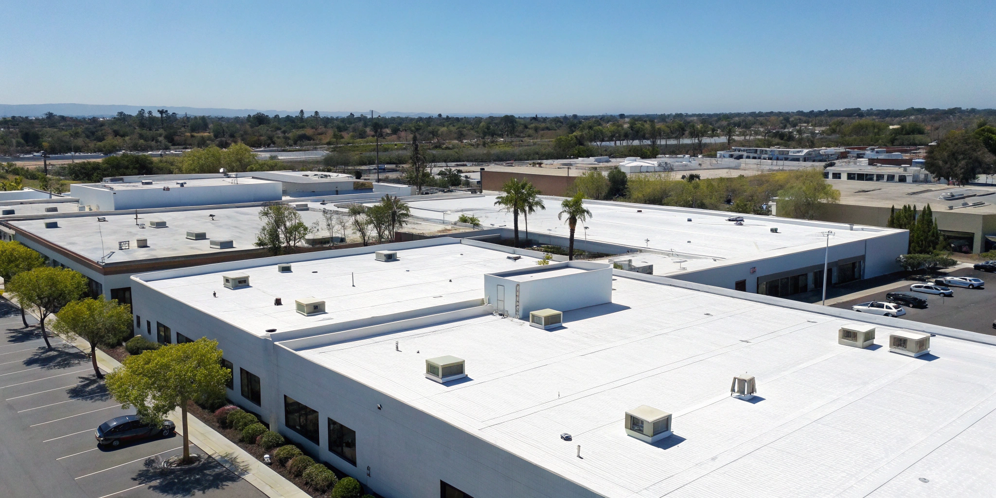 A commercial building with a flat roof, a job for the best commercial roofing companies in California.
