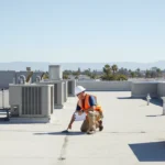 A clean, modern commercial flat roof undergoing professional inspection