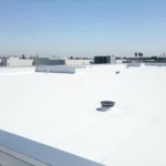 Well-maintained flat roof on a Southern California commercial building with clear drains and membrane surface