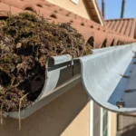 Comparison of clean and clogged residential gutters on a Southern California home