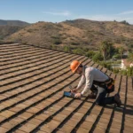 A professional inspector evaluating a classic wood shake roof on a sunny day in Southern California
